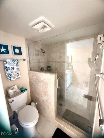 a bathroom with a double vanity sink toilet and a mirror