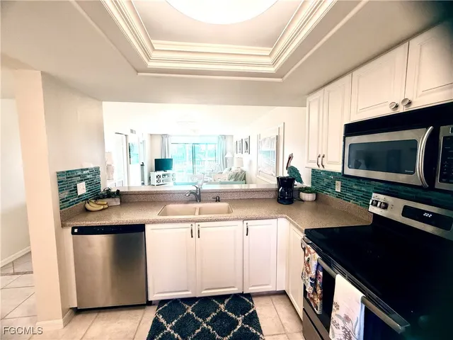 a kitchen with a refrigerator and a stove