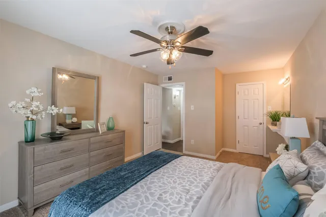 a bedroom with a bed and a chandelier