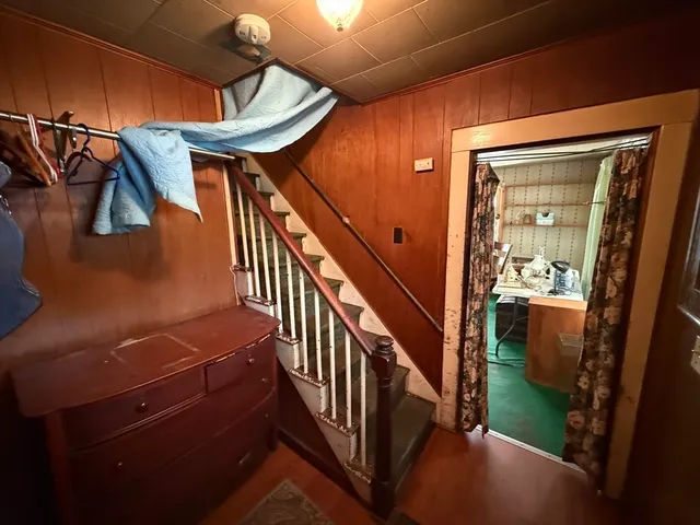 a view of entryway and hall with wooden floor