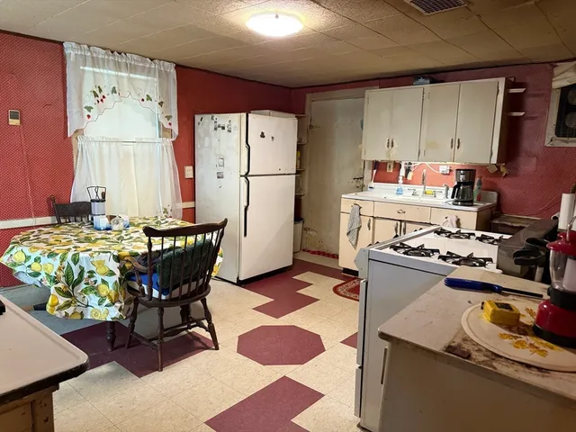 a kitchen with a dining table and chairs