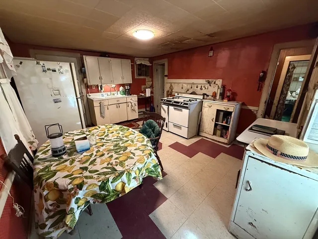 a kitchen with a refrigerator and a stove top oven