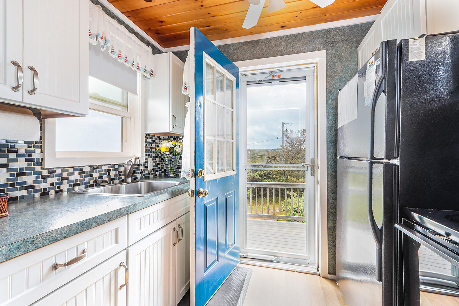 440 Nellie Road Wellfleet, MA 02667 - Photo 11 of 22 a kitchen with refrigerator and window