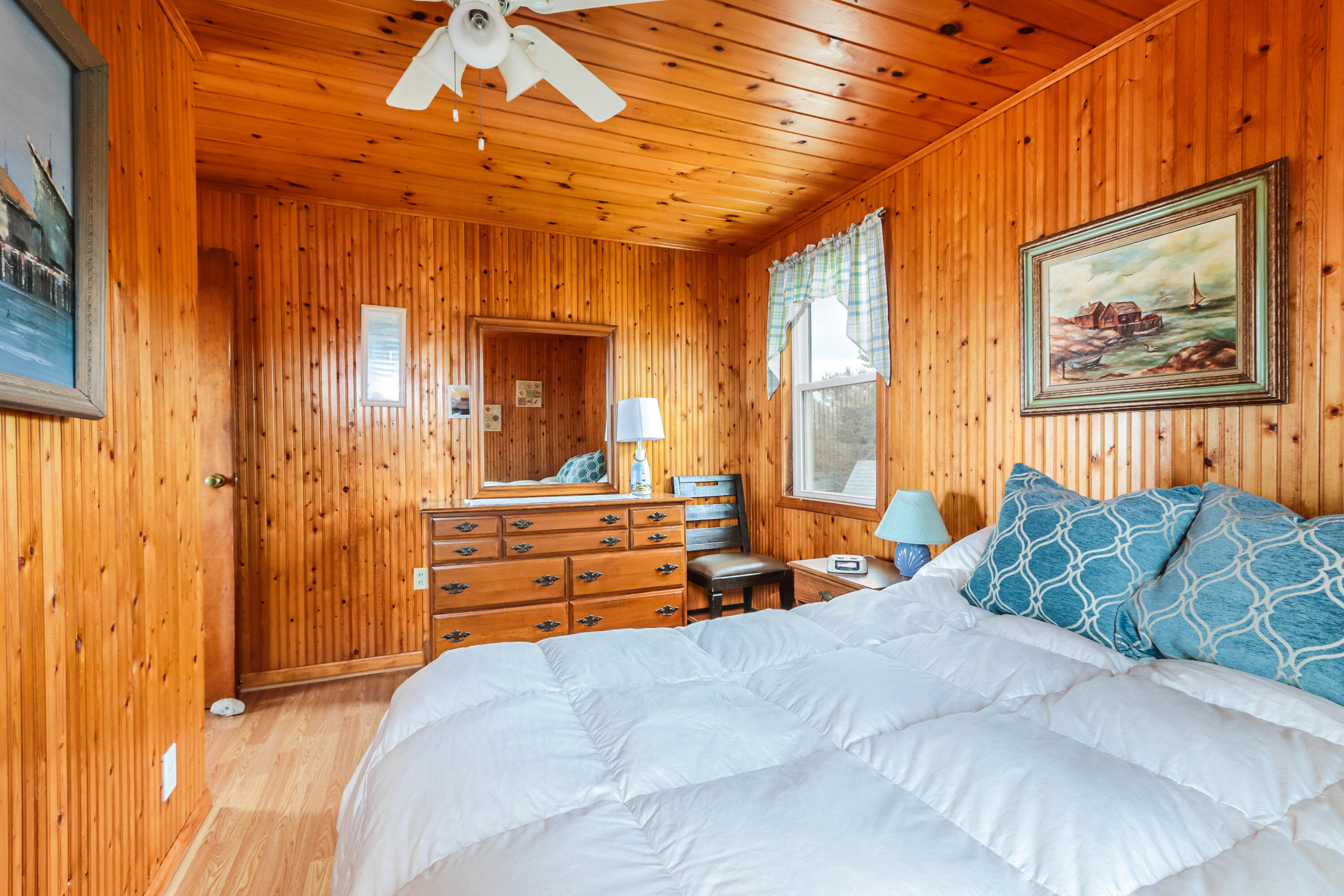 440 Nellie Road Wellfleet, MA 02667 - Photo 16 of 22 a bedroom with a bed and a chandelier
