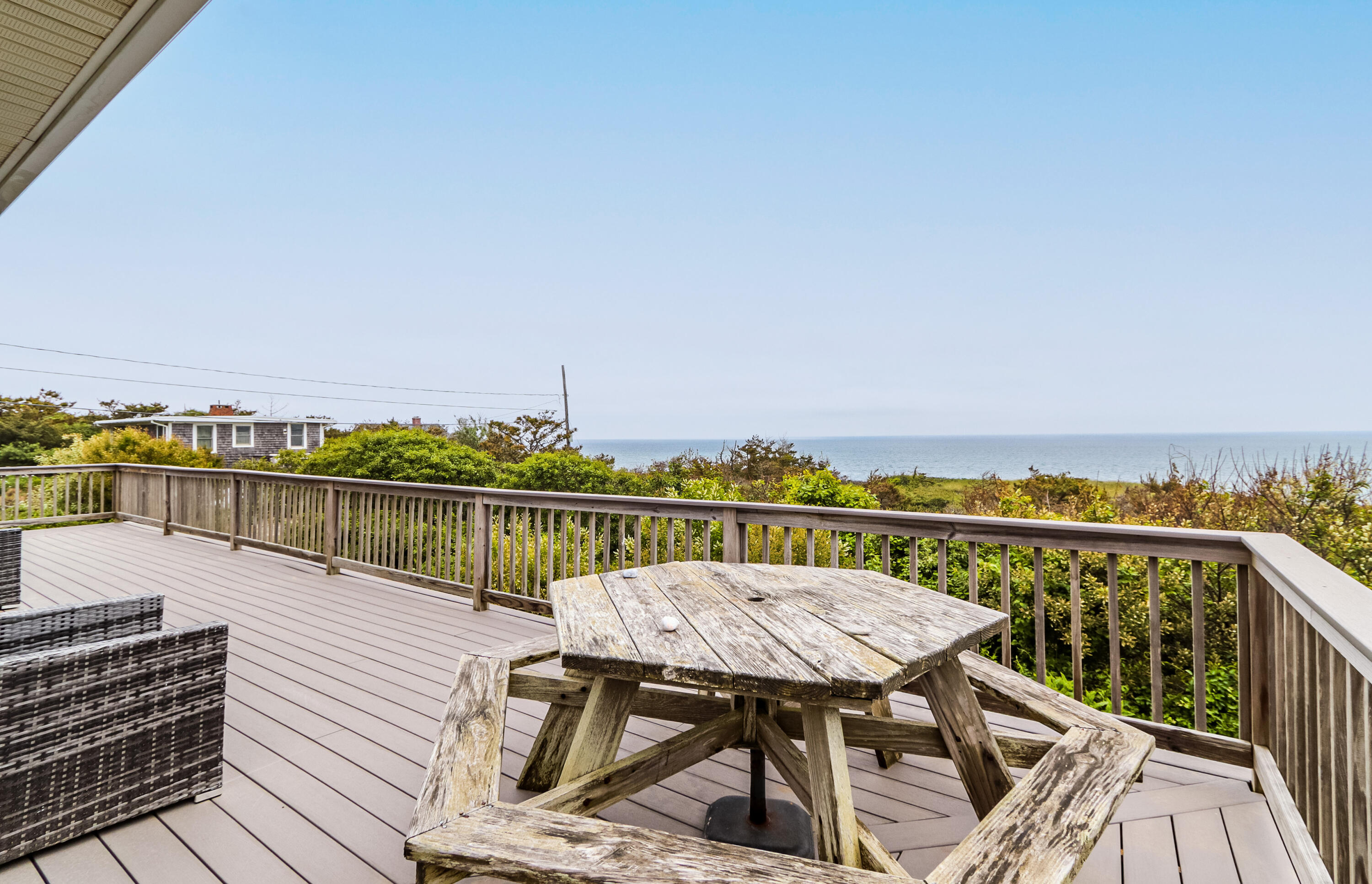 440 Nellie Road Wellfleet, MA 02667 - Photo 20 of 22 a view of a balcony with wooden chairs and floor to ceiling window