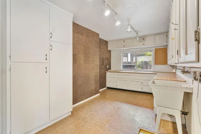 a backyard of a house with a large tree