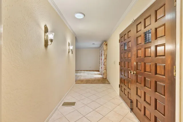 an empty room with fireplace and windows