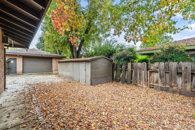an aerial view of a house with a yard and garden