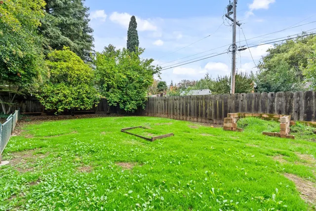 an aerial view of a house with a garden and swimming pool