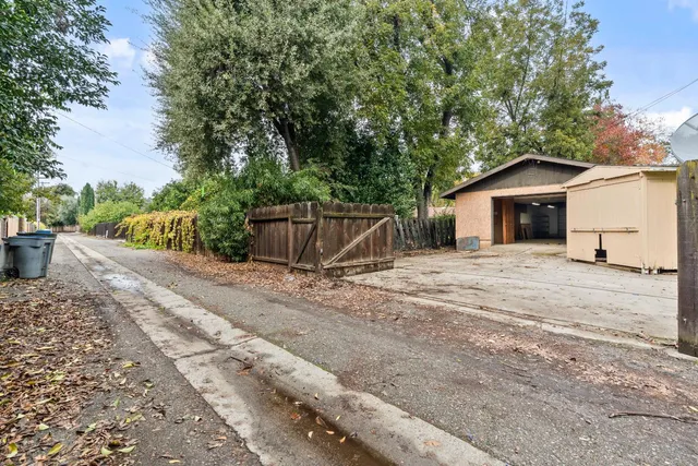 an aerial view of a house with garden space and street view