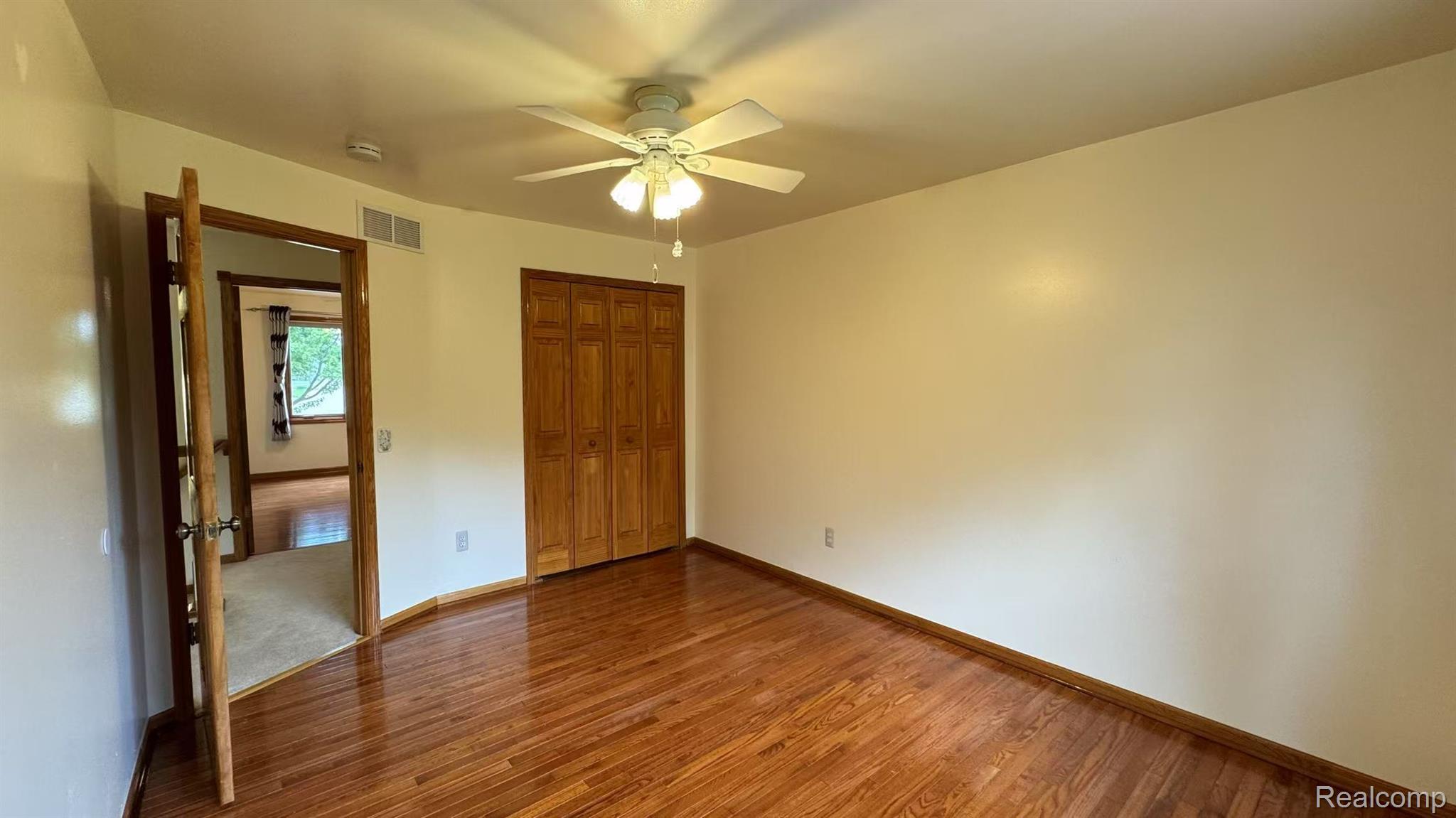 3440 Salem Drive Rochester, MI 48306 - Photo 23 of 33 Interior room featuring wood-finish flooring, light-toned walls, and a ceiling fan with integrated lighting
