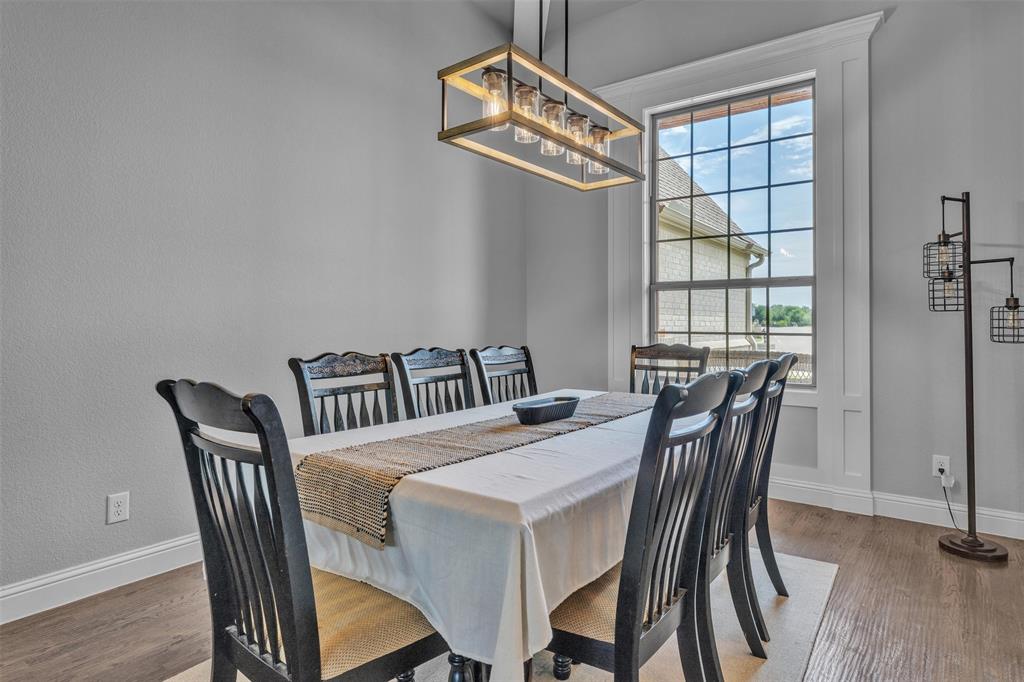 1060 Waters Edge Court Oak Point, TX 75068 - Photo 5 of 40 a view of a dining room that has a table and chairs