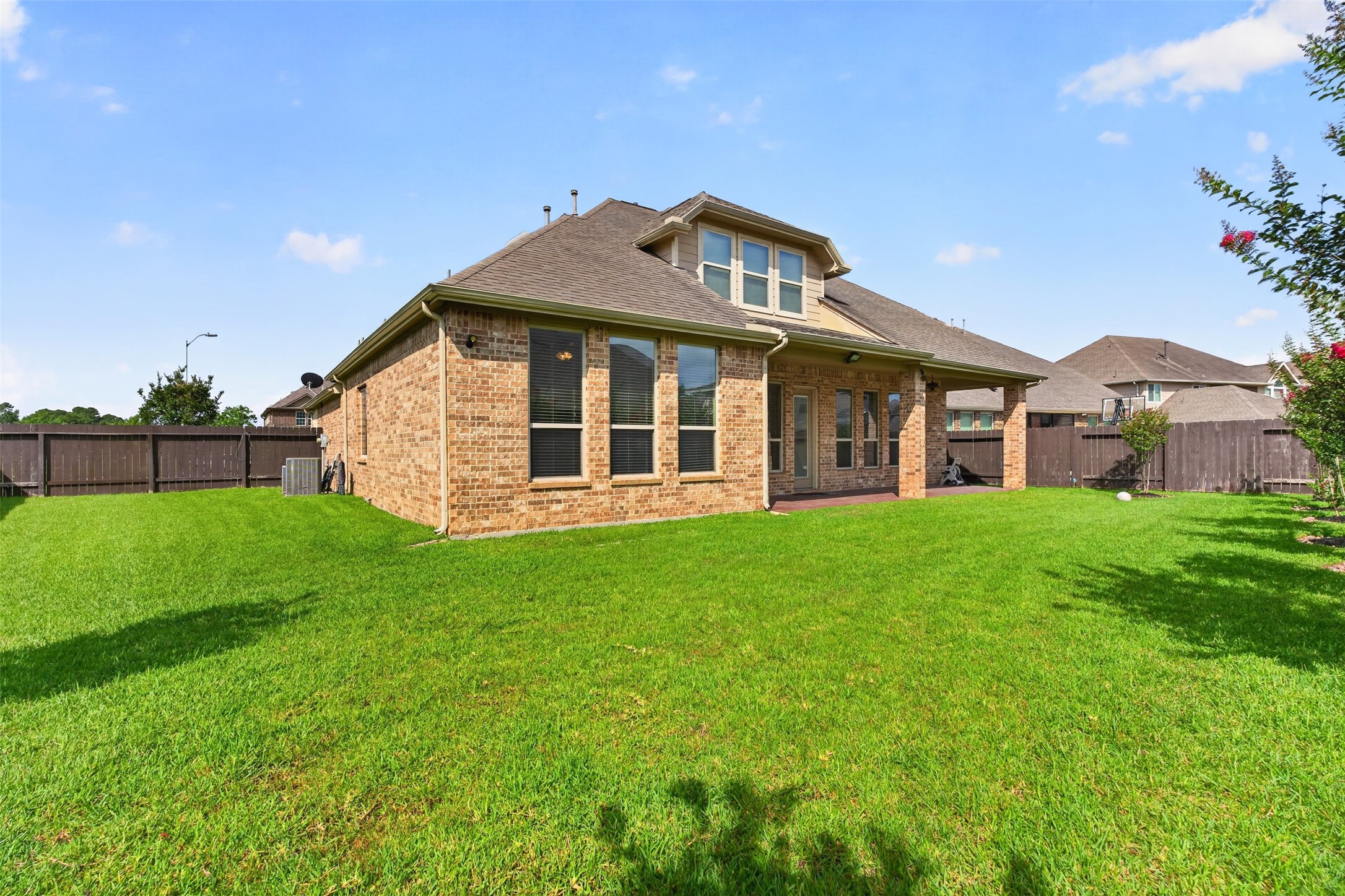 18202 Wedgewood Bluff Court Spring, TX 77379 - Photo 45 of 50 Backyard view of the rear exterior and spacious lawn.