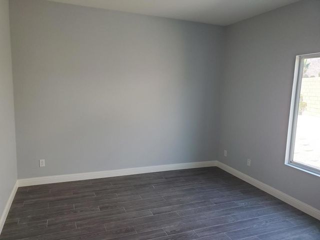wooden floor and window in an empty room