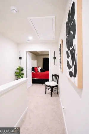 a bedroom with a large bed and a flat tv screen on a dresser