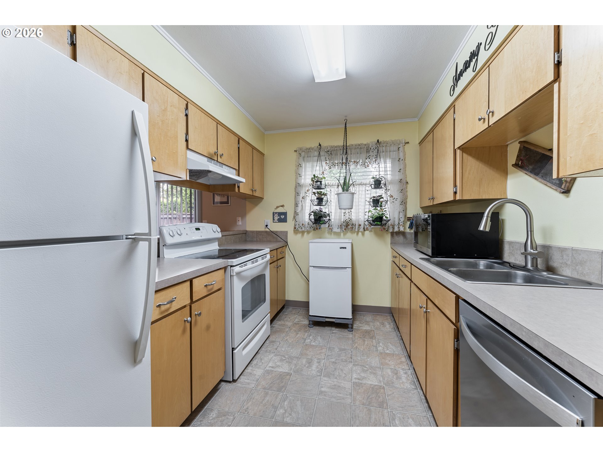 11341 Southwest Springwood Drive Portland, OR 97223 - Photo 11 of 26 a kitchen that has a sink and a stove in it