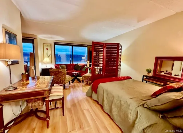 a bedroom with furniture and a wooden floor