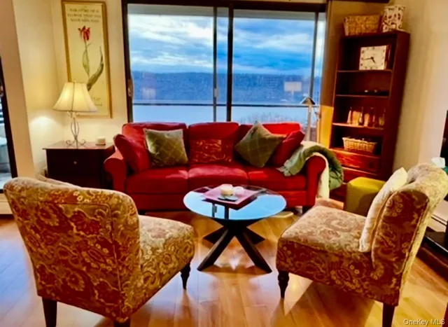 a living room with furniture and a painting on the wall