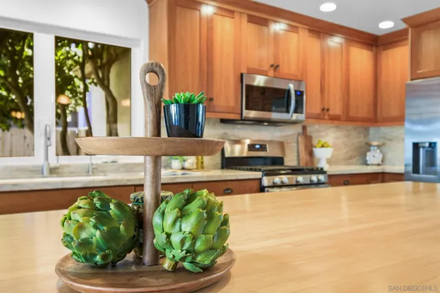 a kitchen with a sink a microwave and cabinets