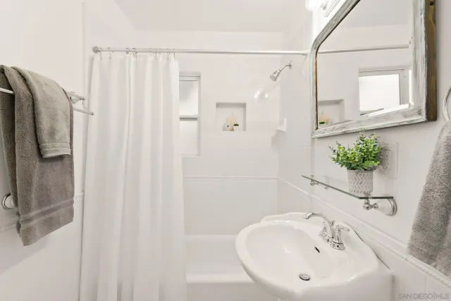 a bathroom with a sink a mirror and a shower