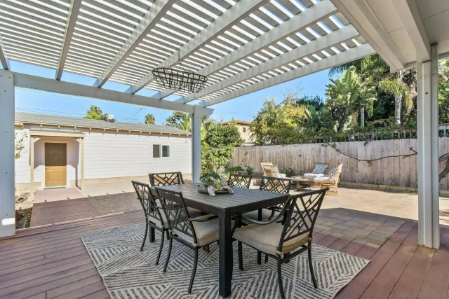 a view of a table and chairs in patio with potted plants
