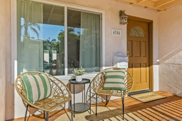 a balcony with table and chairs