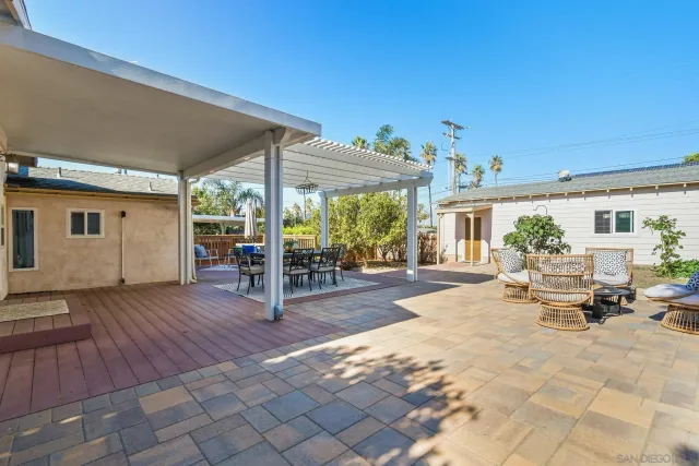 a view of a house with backyard porch and sitting area
