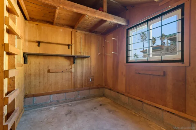 a view of a room with wooden walls and a window