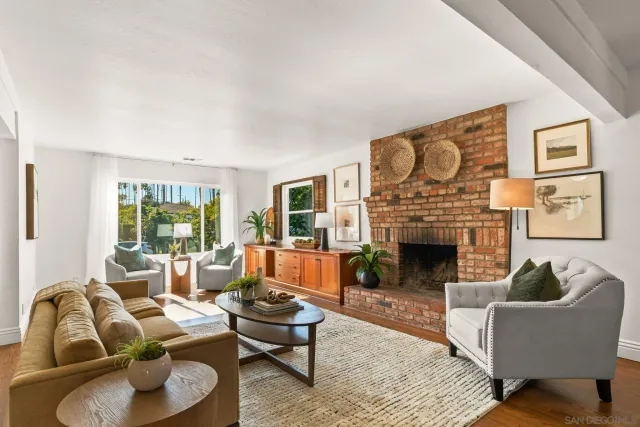 a living room with furniture fireplace and window