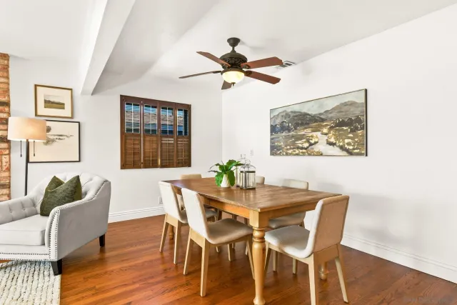 a dining room with furniture a window and wooden floor