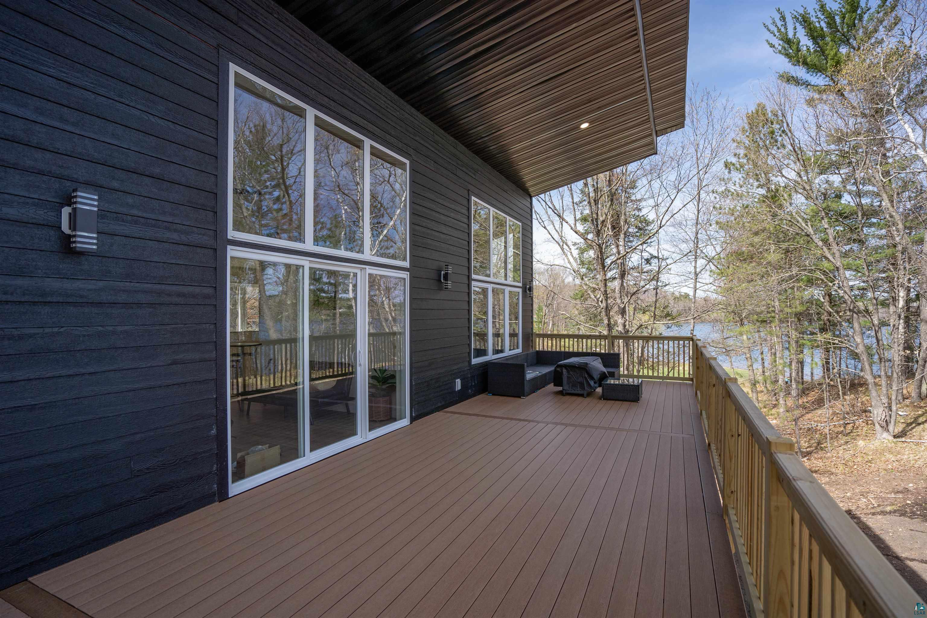 2000 West Chub Lake Road Carlton, MN 55718 - Photo 3 of 30 Expansive outdoor deck with composite flooring and a wooden railing