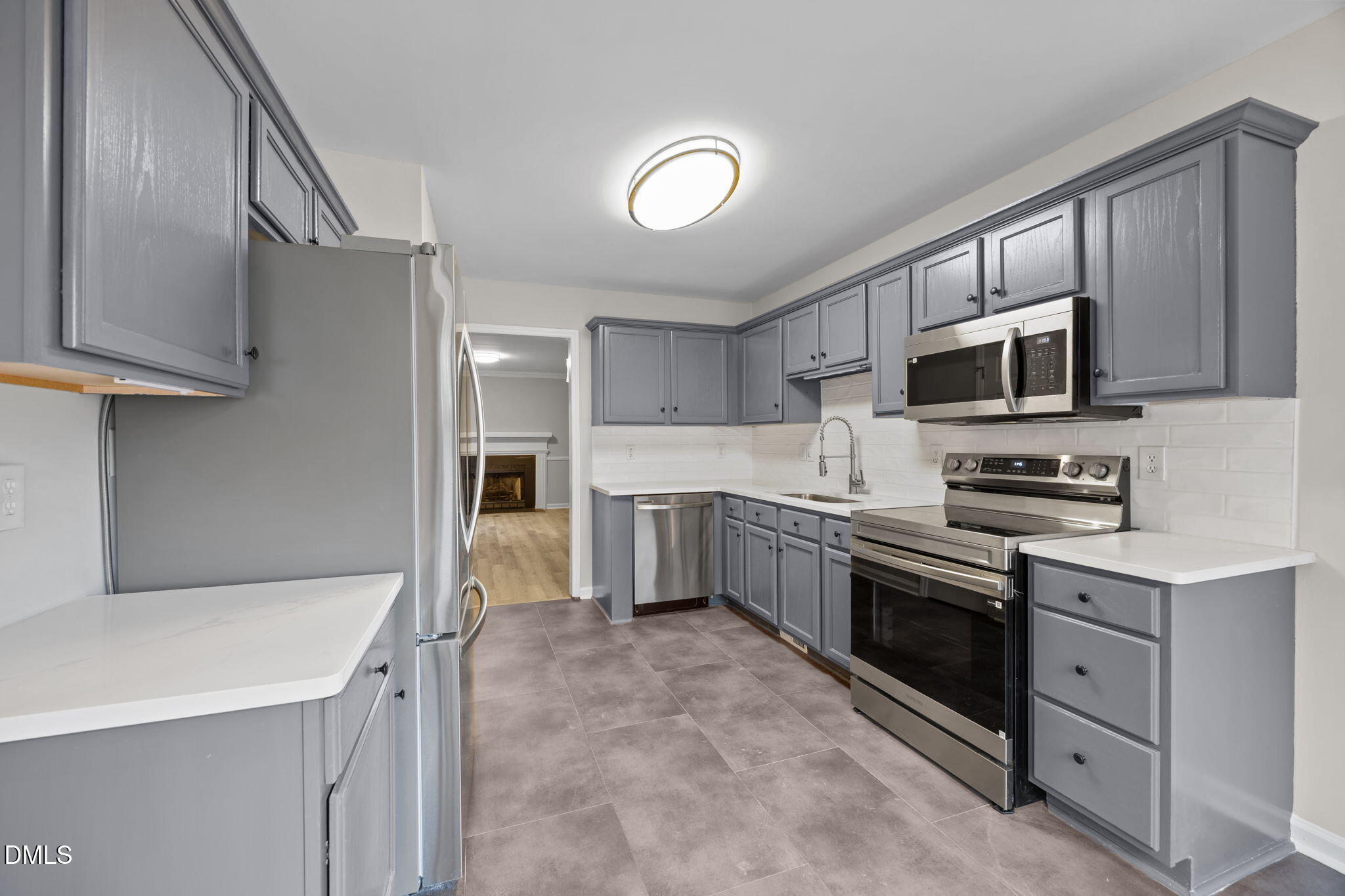 2813 Bedfordshire Court Raleigh, NC 27604 - Photo 12 of 44 a kitchen with stainless steel appliances granite countertop a refrigerator stove and sink
