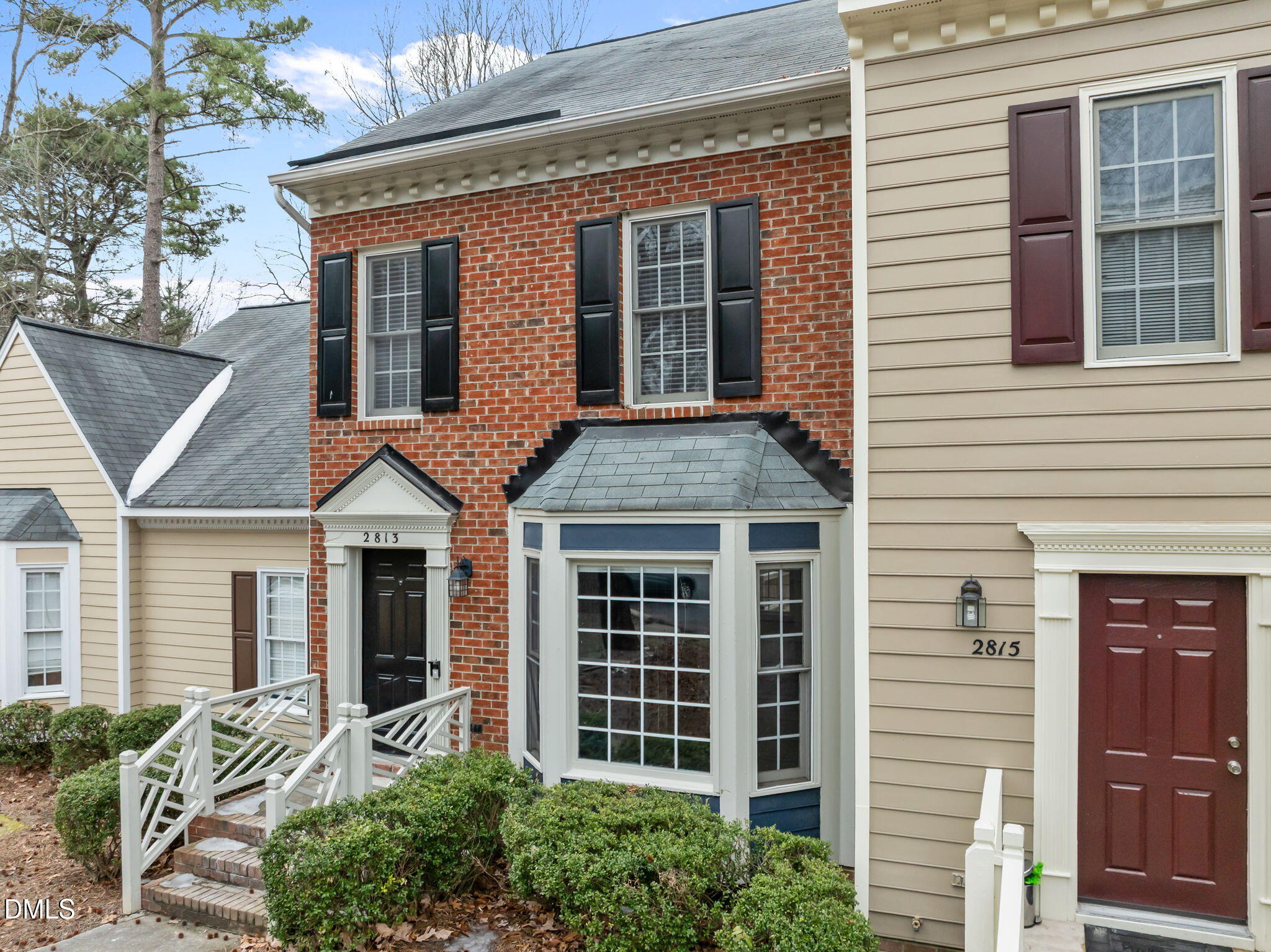 2813 Bedfordshire Court Raleigh, NC 27604 - Photo 2 of 44 a view of a brick house with large windows and plants