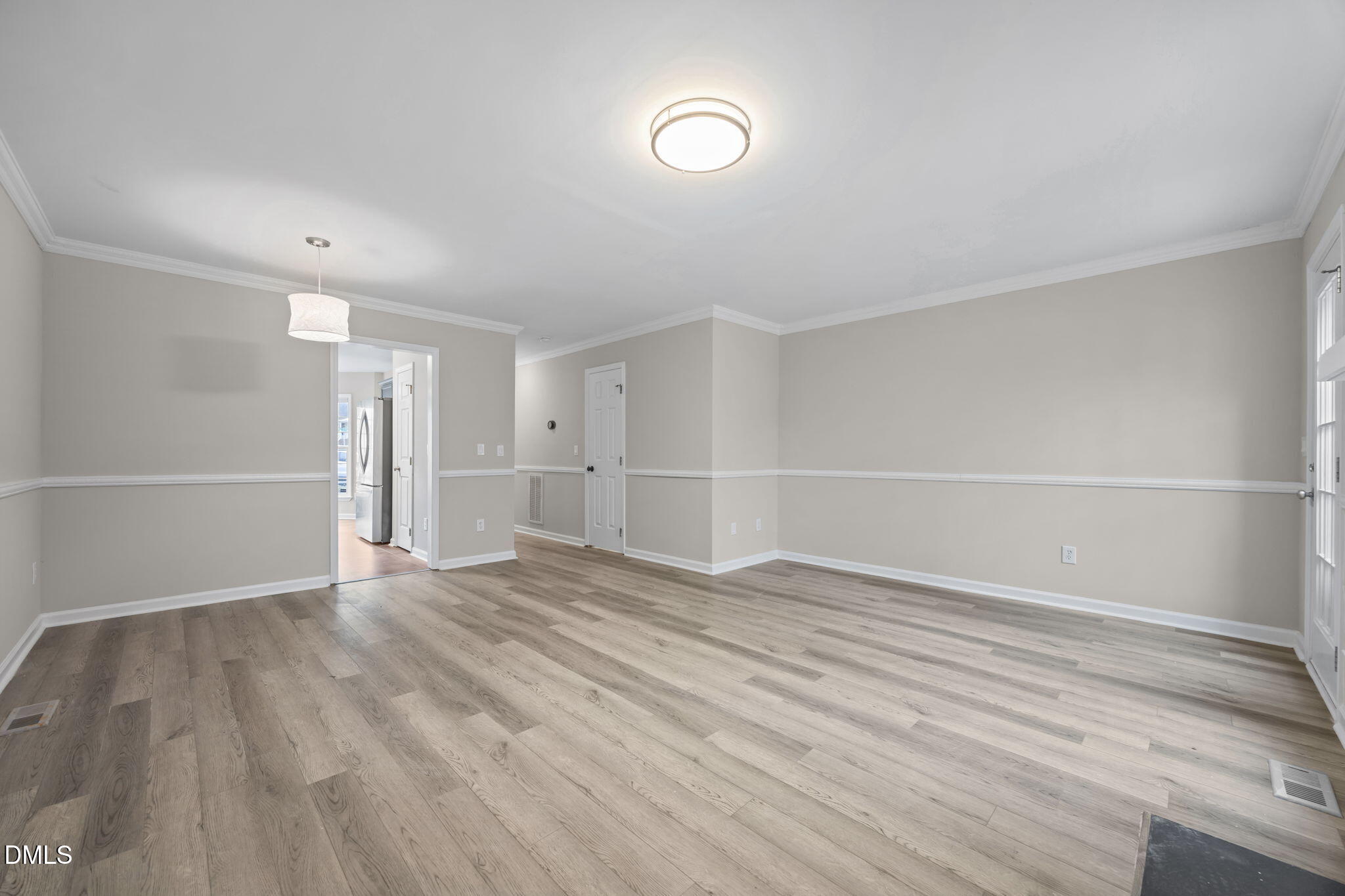 2813 Bedfordshire Court Raleigh, NC 27604 - Photo 8 of 44 a view of an empty room with wooden floor