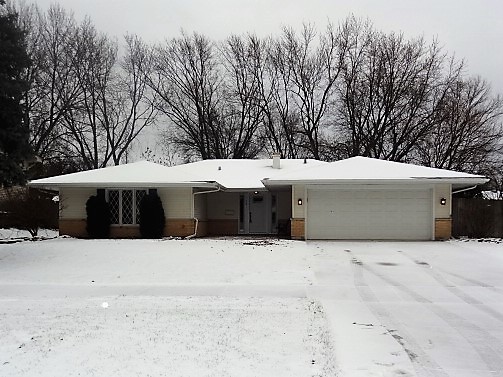 21 Buckingham Road Glen Ellyn, IL 60137 - Photo 1 of 38 a view of white house with a yard covered with snow in front of house