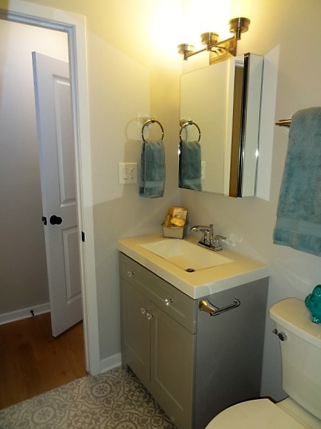 21 Buckingham Road Glen Ellyn, IL 60137 - Photo 24 of 38 a bathroom with a sink and mirror with toilet