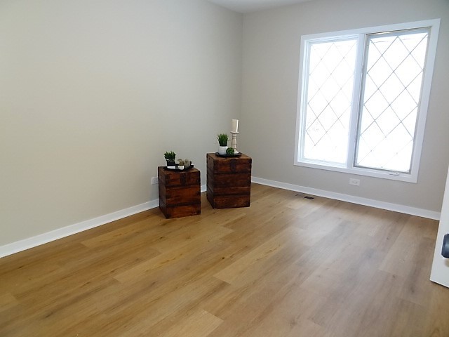 21 Buckingham Road Glen Ellyn, IL 60137 - Photo 27 of 38 an empty room with wooden floor and windows