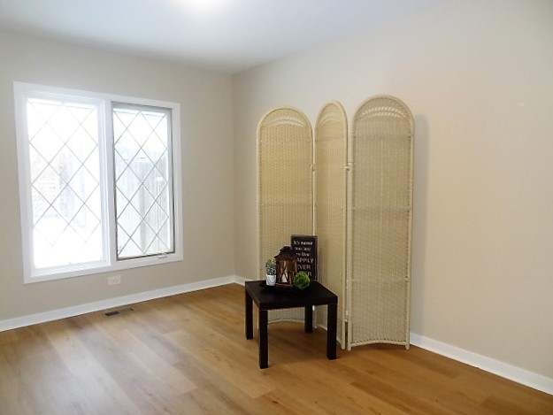 21 Buckingham Road Glen Ellyn, IL 60137 - Photo 29 of 38 a view of a room that has a window and wooden floor