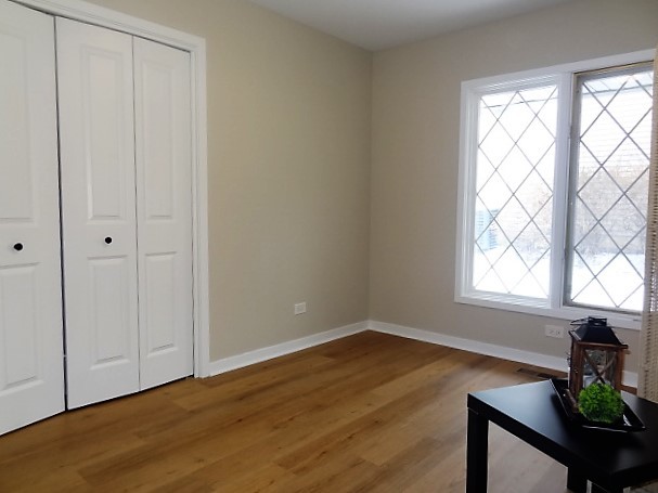 21 Buckingham Road Glen Ellyn, IL 60137 - Photo 30 of 38 a view of an empty room with wooden floor and a window