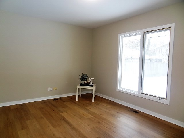 21 Buckingham Road Glen Ellyn, IL 60137 - Photo 31 of 38 an empty room with wooden floor and windows