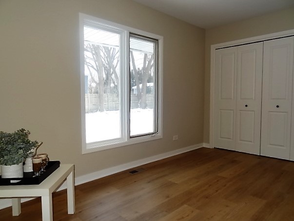 21 Buckingham Road Glen Ellyn, IL 60137 - Photo 32 of 38 a view of an empty room with wooden floor and a window