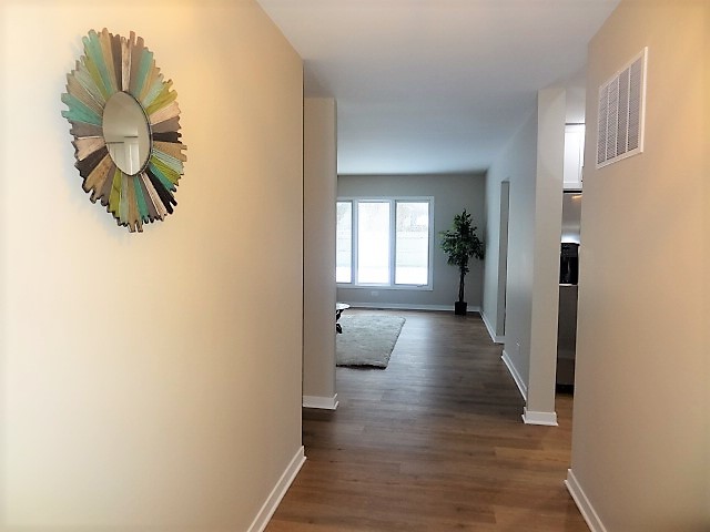 21 Buckingham Road Glen Ellyn, IL 60137 - Photo 4 of 38 a view of a hallway with wooden floor and staircase
