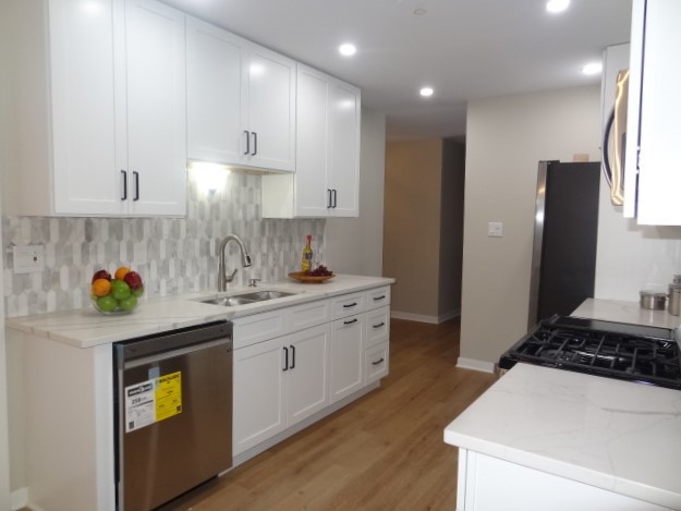 21 Buckingham Road Glen Ellyn, IL 60137 - Photo 6 of 38 a kitchen with a sink a stove cabinets and wooden floor