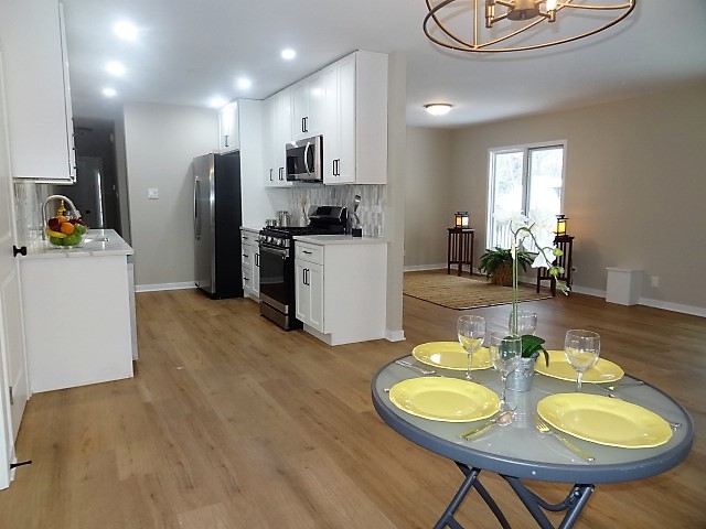 21 Buckingham Road Glen Ellyn, IL 60137 - Photo 10 of 38 a kitchen with sink refrigerator dining table and chairs