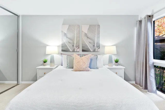 a bed room with a bed and a night stand