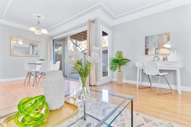 a living room with furniture and a wooden floor