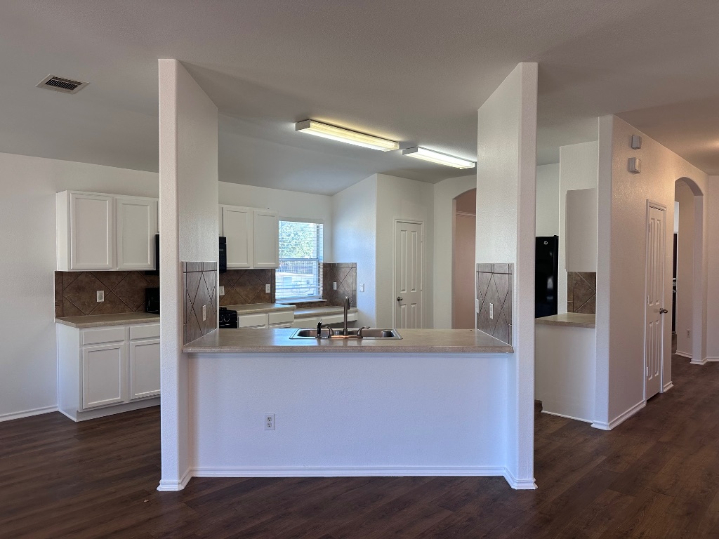 12720 Waynespur Lane Elgin, TX 78621 - Photo 12 of 31 a kitchen with stainless steel appliances a refrigerator sink and microwave