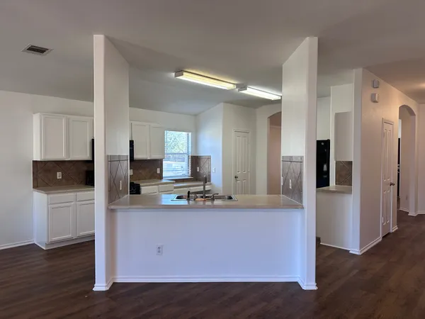 a kitchen with stainless steel appliances a refrigerator sink and microwave