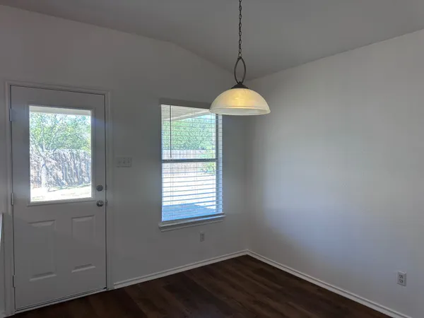 a room with window and chandelier