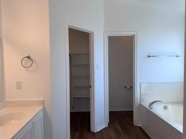 a bathroom with a tub a sink and a shower